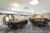 Meeting room setup with square tables and arched windows